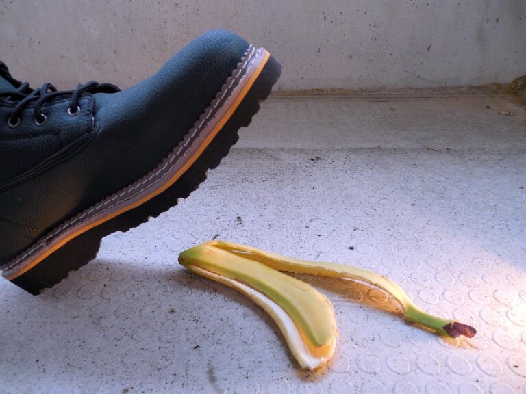 A person about to slip on a banana peel, representing a potential slip and fall injury compensation claim in a public place.