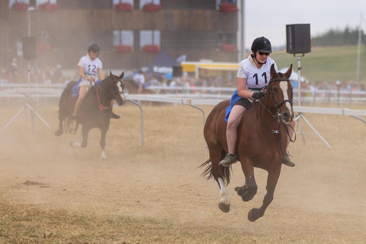 Female horse riders in a race, representing potential scenarios where personal injury claims may arise from sporting accidents.