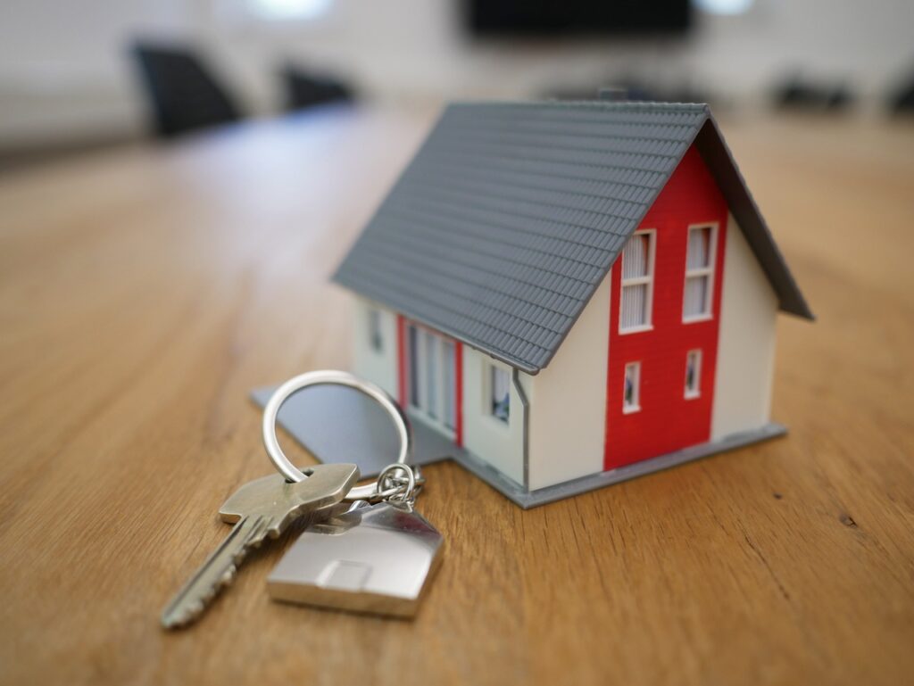 Model house with keys, representing property transactions and the need for strong conveyancing cybersecurity to protect client data.