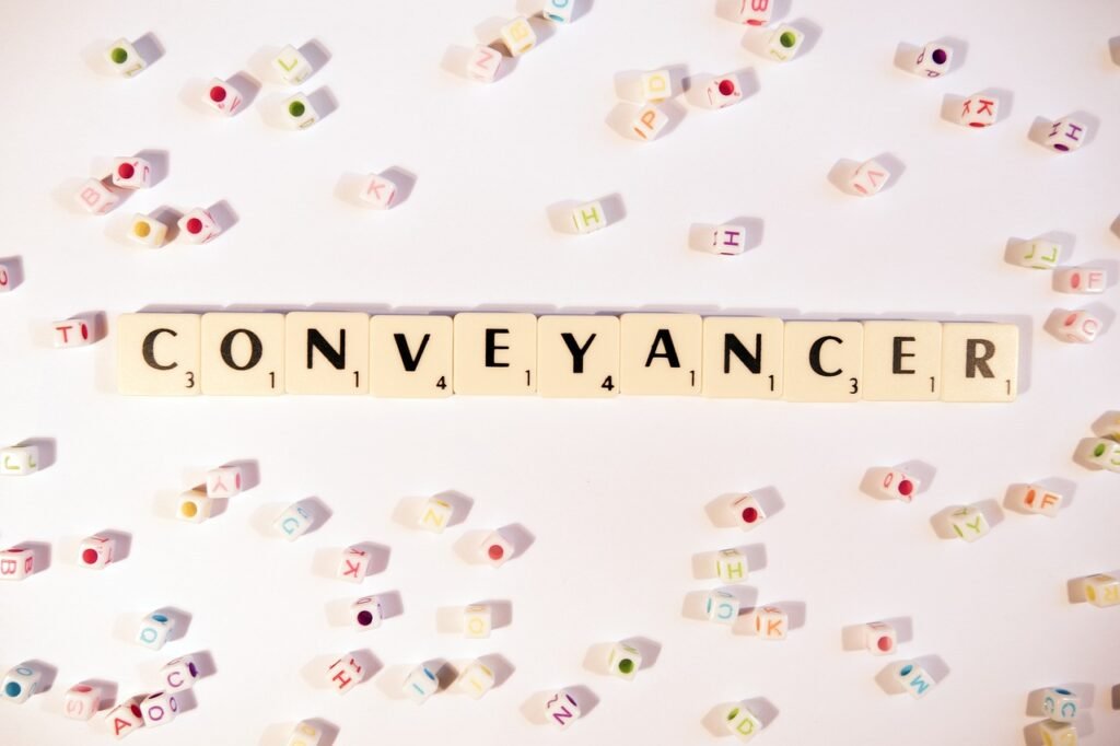 QES conveyancing concept with conveyancer word in scrabble tiles