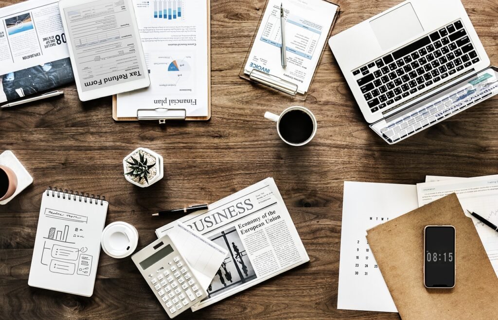Busy office desk with paperwork and coffee, showing workload pressure that contributes to workplace stress claims.